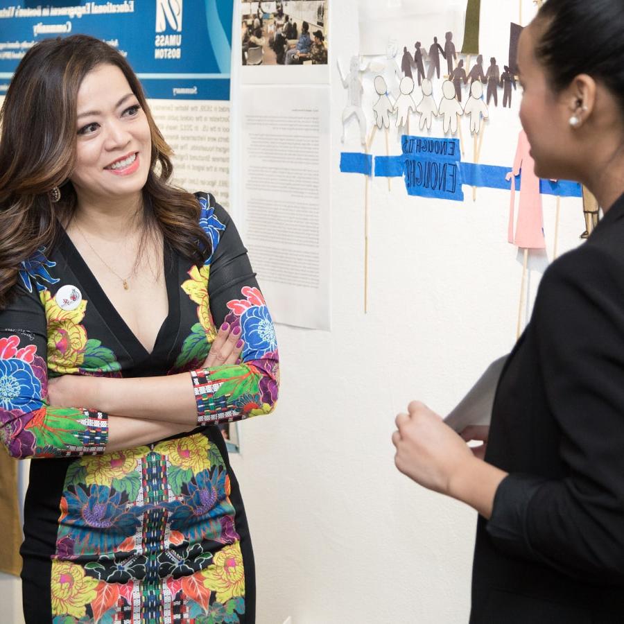 Professor Shirley Tang talks to student.